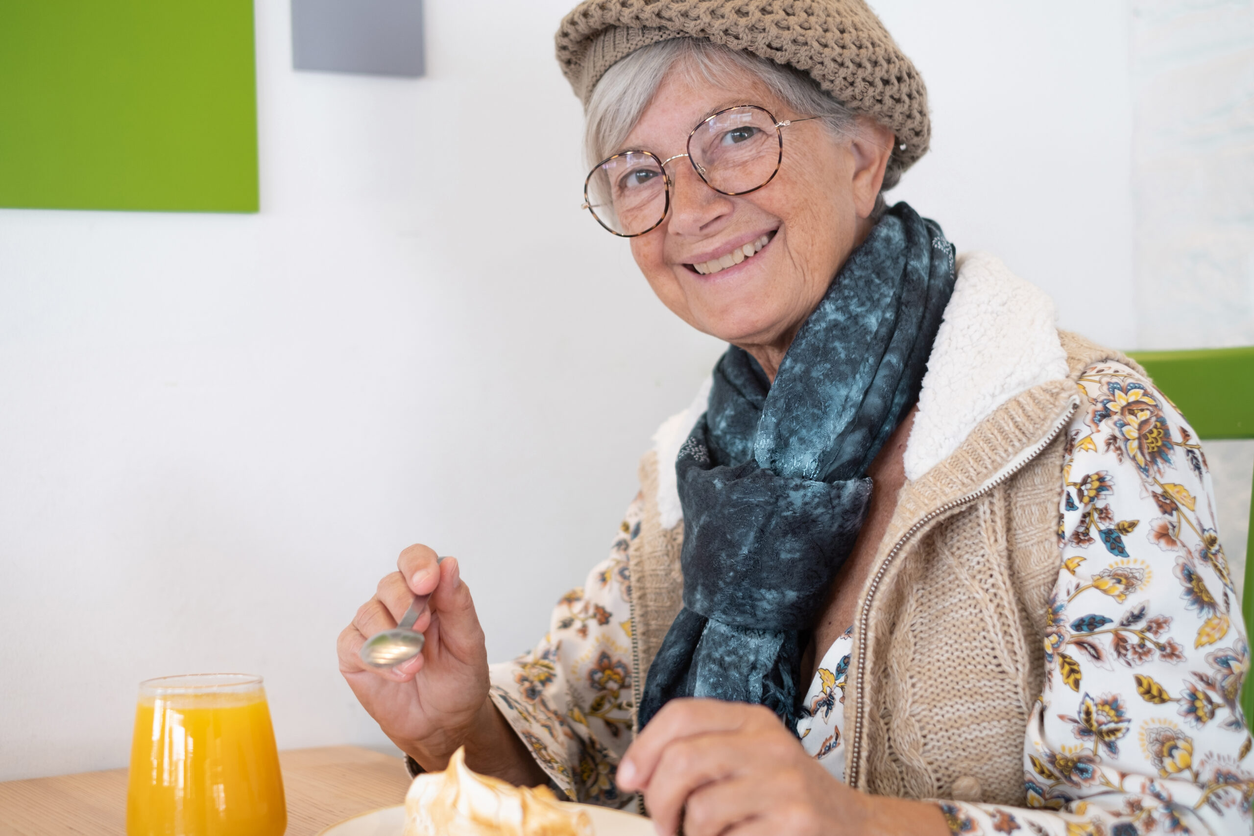 beautiful caucasian senior woman sitting for breakfast in cafe,